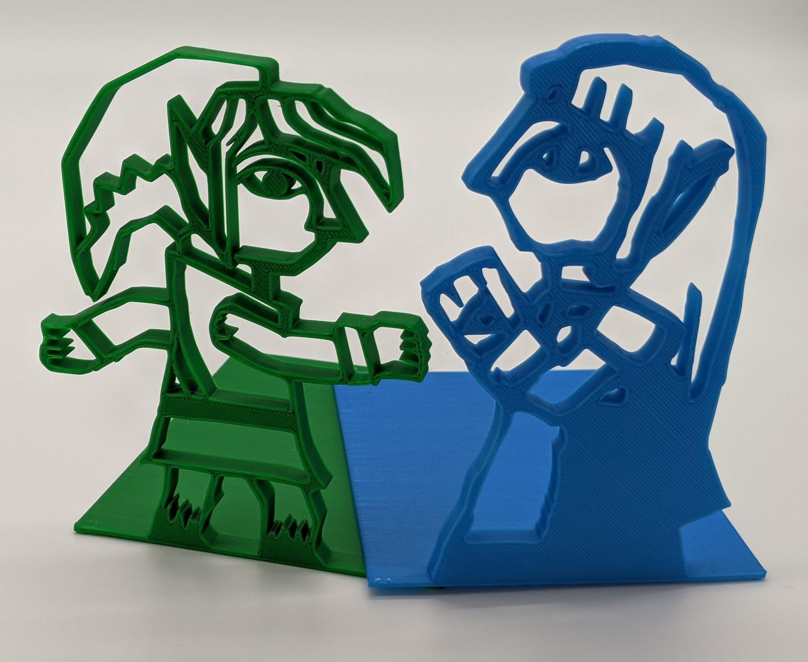 3D-printed bookends: green Link mid-swing and blue Princess Zelda, from The Legend of Zelda