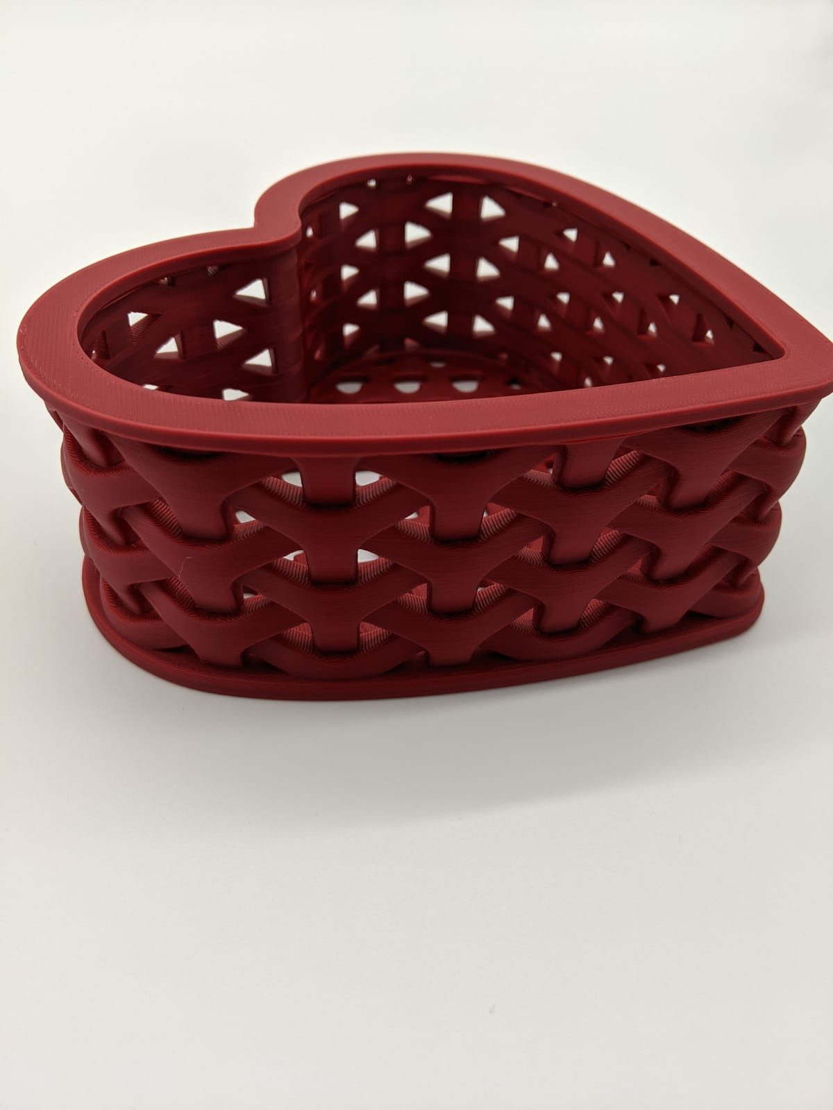 Red heart-shaped 3D-printed basket with a woven-looking texture